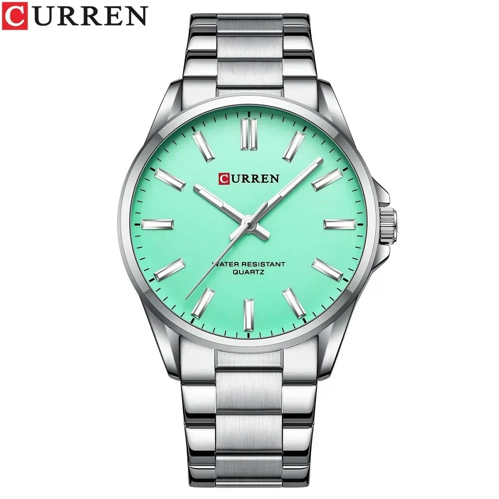 Reloj Curren 9090G de cuarzo con esfera de color Plateado Turquesa,, caja y pulsera de acero inoxidable, cristal Hardlex y manecillas luminiscentes para el hombre moderno